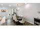 Bright dining room features hardwood floors, modern lighting, and a view to the outdoor area at 309 Millennium Dr, Pittsboro, NC 27312
