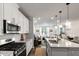 Well-lit kitchen with stainless steel appliances, gas range, island with sink, and open layout at 309 Millennium Dr, Pittsboro, NC 27312
