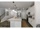 Spacious kitchen with an island, stainless steel appliances, and open access to the living area at 309 Millennium Dr, Pittsboro, NC 27312