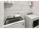 Well-lit laundry room featuring modern, front-load washer and dryer, with a convenient storage shelf above at 309 Millennium Dr, Pittsboro, NC 27312