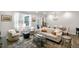 Open living room featuring hardwood floors, natural light, and an open layout into the dining area at 309 Millennium Dr, Pittsboro, NC 27312