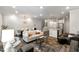 Expansive living space boasts hardwood floors, modern lighting, and comfortable seating arrangements at 309 Millennium Dr, Pittsboro, NC 27312