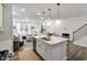 Spacious living space featuring an island kitchen and views into the formal dining and living room area at 309 Millennium Dr, Pittsboro, NC 27312