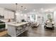 Stylish living space with a seamless open-concept kitchen, dining, and living room for entertaining at 309 Millennium Dr, Pittsboro, NC 27312