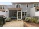 Townhome's charming patio with pavers and a screened-in porch for enjoying the outdoors at 309 Millennium Dr, Pittsboro, NC 27312