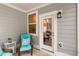 This gray home features a charming patio and porch with a view to the outside at 309 Millennium Dr, Pittsboro, NC 27312