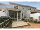 The gray home's patio has pavers and a screened-in porch for enjoying the outdoors at 309 Millennium Dr, Pittsboro, NC 27312