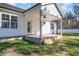 Covered back porch with ceiling fan, wooden steps, and access to the home's interior through a glass-paneled door at 32 Bonnybrook Ct, Selma, NC 27576