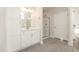 This bathroom has a glass shower, white cabinets, tile flooring, and modern vanity lighting at 32 Bonnybrook Ct, Selma, NC 27576