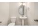 This home features a convenient half-bath with pedestal sink, toilet and custom mirror at 32 Bonnybrook Ct, Selma, NC 27576