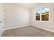 Bedroom with neutral walls, plush carpet, and natural light streaming through the window at 32 Bonnybrook Ct, Selma, NC 27576