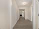 Inviting hallway with durable gray flooring leading to a bright and open living area at 32 Bonnybrook Ct, Selma, NC 27576