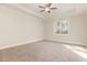 Spacious main bedroom featuring plush carpeting, a ceiling fan, and ample natural light at 32 Bonnybrook Ct, Selma, NC 27576