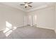 This main bedroom boasts neutral paint, plush carpeting, ceiling fan, and en-suite bath access at 32 Bonnybrook Ct, Selma, NC 27576