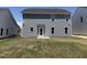 Backyard of house with gray siding, dark roof, grass and windows at 33 W Emily Gardens Dr, Selma, NC 27576