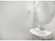 Minimalist powder room featuring a pedestal sink and an oval mirror at 33 W Emily Gardens Dr, Selma, NC 27576