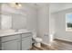 Neutral bathroom with shaker-style vanity, laminate floor, and combination tub and shower at 33 W Emily Gardens Dr, Selma, NC 27576