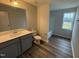 Bathroom with a single sink vanity, grey cabinets, and luxury vinyl tile at 33 W Emily Gardens Dr, Selma, NC 27576