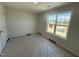 Bedroom with carpet, fresh paint, double-hung window with view, and electrical outlets at 33 W Emily Gardens Dr, Selma, NC 27576