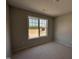 A new bedroom features a large window offering natural light, with neutral walls awaiting personalization at 33 W Emily Gardens Dr, Selma, NC 27576