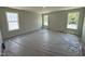 A bedroom with neutral-colored walls and carpet, featuring three large windows for lots of natural light at 33 W Emily Gardens Dr, Selma, NC 27576