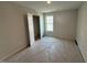 A bedroom with a window, closet and neutral-colored walls and carpet at 33 W Emily Gardens Dr, Selma, NC 27576