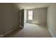 Unfinished bedroom with large window and closet door at 33 W Emily Gardens Dr, Selma, NC 27576
