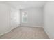 A bedroom with neutral carpet, bright walls, a window, and a double-door closet at 33 W Emily Gardens Dr, Selma, NC 27576