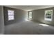 Bright, unfinished bedroom with three large windows offering natural light at 33 W Emily Gardens Dr, Selma, NC 27576