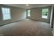 Large bedroom with carpet floors, three windows with natural light at 33 W Emily Gardens Dr, Selma, NC 27576