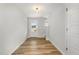 Bright entryway featuring wood-look floors, a white door with glass, and a staircase at 33 W Emily Gardens Dr, Selma, NC 27576