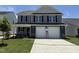 Charming two-story home with a gray exterior, a two-car garage, and a well-manicured lawn at 33 W Emily Gardens Dr, Selma, NC 27576