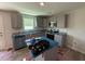 Modern kitchen with stainless steel appliances, gray cabinets, and granite countertops, great for cooking and entertaining at 33 W Emily Gardens Dr, Selma, NC 27576