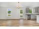 Open kitchen with gray cabinets, stainless steel appliances, and wood-look floors at 33 W Emily Gardens Dr, Selma, NC 27576