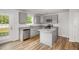Well-lit kitchen featuring gray cabinets, stainless steel appliances, and a center island at 33 W Emily Gardens Dr, Selma, NC 27576