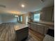 Kitchen with gray cabinets, granite countertops, stainless steel appliances and an island at 33 W Emily Gardens Dr, Selma, NC 27576