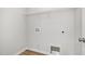 A utility room with light gray walls and trim, connections for laundry, and white shelving at 33 W Emily Gardens Dr, Selma, NC 27576