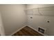 Small laundry room space with utility connections and a wire shelf at 33 W Emily Gardens Dr, Selma, NC 27576