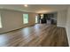 Open-concept living room and kitchen with hardwood floors and modern lighting at 33 W Emily Gardens Dr, Selma, NC 27576