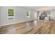 Open-concept living room with wood-look floors leading to the kitchen at 33 W Emily Gardens Dr, Selma, NC 27576