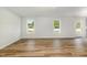 Spacious living room with light walls, wood-look floors, and natural light from windows at 33 W Emily Gardens Dr, Selma, NC 27576