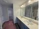 Large bathroom with dual sinks, vanity, walk-in shower, and large mirror at 33 W Emily Gardens Dr, Selma, NC 27576
