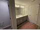 Large bathroom with dual sinks, vanity, walk-in shower, and large mirror at 33 W Emily Gardens Dr, Selma, NC 27576