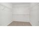 A spacious walk-in closet with neutral carpet and white wire shelving on all sides at 33 W Emily Gardens Dr, Selma, NC 27576