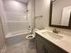 Clean bathroom featuring a vanity, and a tub/shower combination with gray cabinets and quartz countertops at 39 N Rowsham Pl, Smithfield, NC 27577