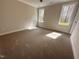 Bright, carpeted bedroom with natural light streaming through two windows with neutral colored walls at 39 N Rowsham Pl, Smithfield, NC 27577