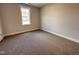Empty bedroom with neutral colored walls, carpeted floors, and a window at 39 N Rowsham Pl, Smithfield, NC 27577
