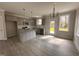 Modern kitchen with gray cabinets, granite countertops, stainless steel appliances, and wood-look flooring at 39 N Rowsham Pl, Smithfield, NC 27577