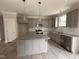Modern kitchen featuring gray cabinets, granite countertops, and stainless steel appliances with pendant lights at 39 N Rowsham Pl, Smithfield, NC 27577