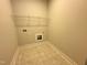 Well-lit laundry room featuring tile flooring, a built-in shelf, and utility hookups at 39 N Rowsham Pl, Smithfield, NC 27577